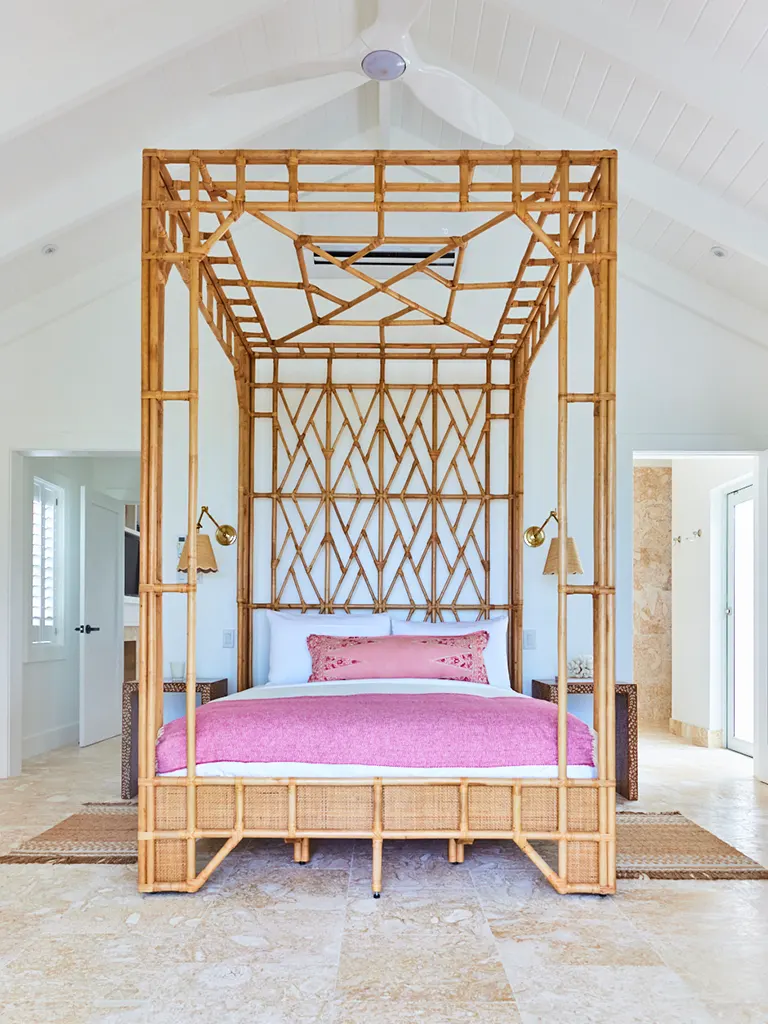 Rattan four-poster bed in Pink Sands House at The Potlatch Club, Eleuthera