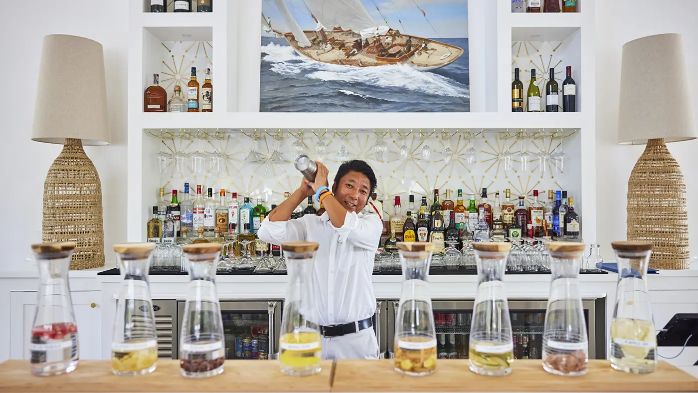 Gembo shaking up a Caribbean cocktail in the Fig Tree restaurant bar at The Potlatch Club Eleuthera