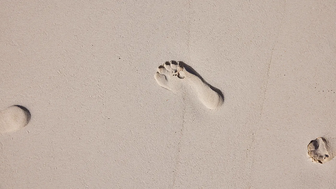 Footprints in pink sand at The Potlatch Club, Eleuthera