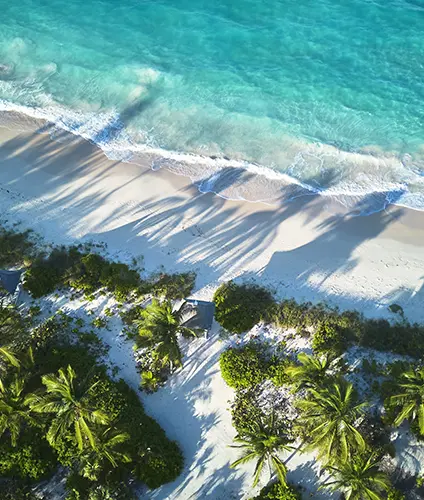 Shadows fall on The Potlatch Club brach, Eleuthera